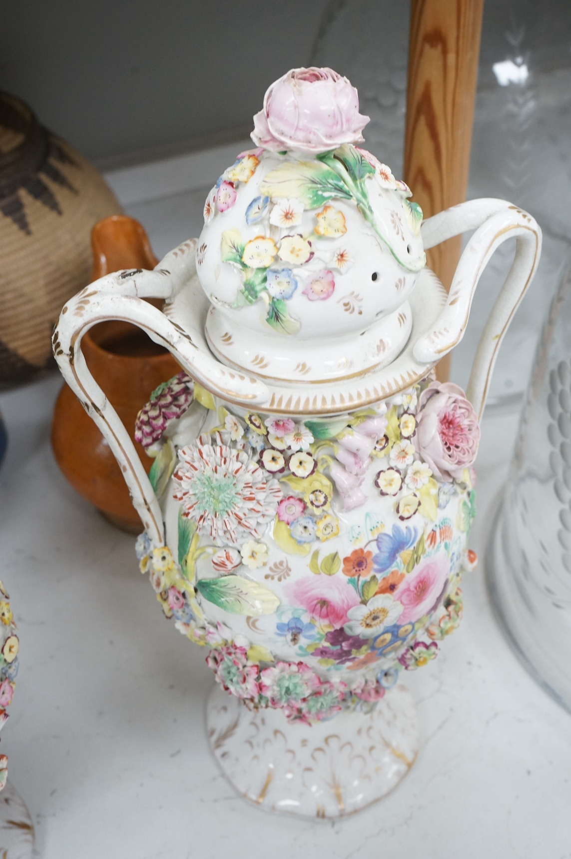 A pair of Victorian Staffordshire porcelain floral-encrusted vases and covers, 44cm high. Condition - some damage